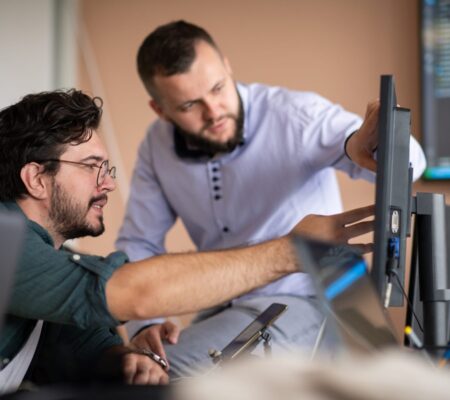 Programmers engrossed in deep collaboration, diligently working together to solve complex problems Programmers engrossed in deep collaboration, diligently working together to solve complex problems and develop innovative mobile applications with seamless functionality